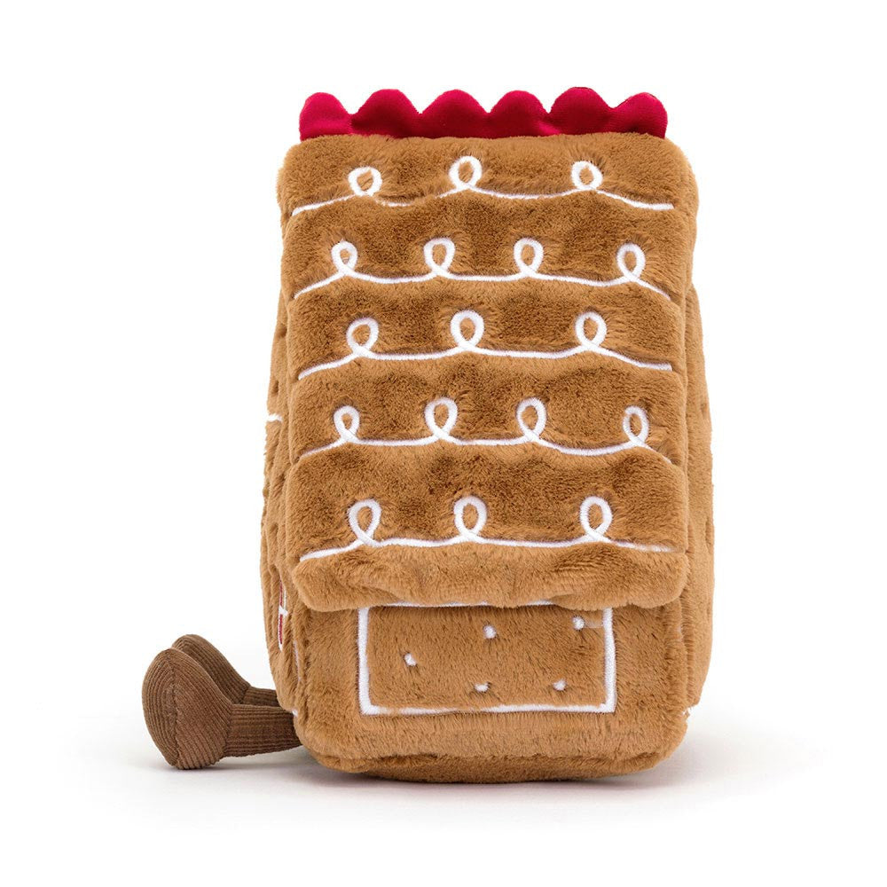 Vista lateral da Amuseables Gingerbread House da Jellycat – peluche natalício com formato de casa de gengibre, cheio de detalhes encantadores.