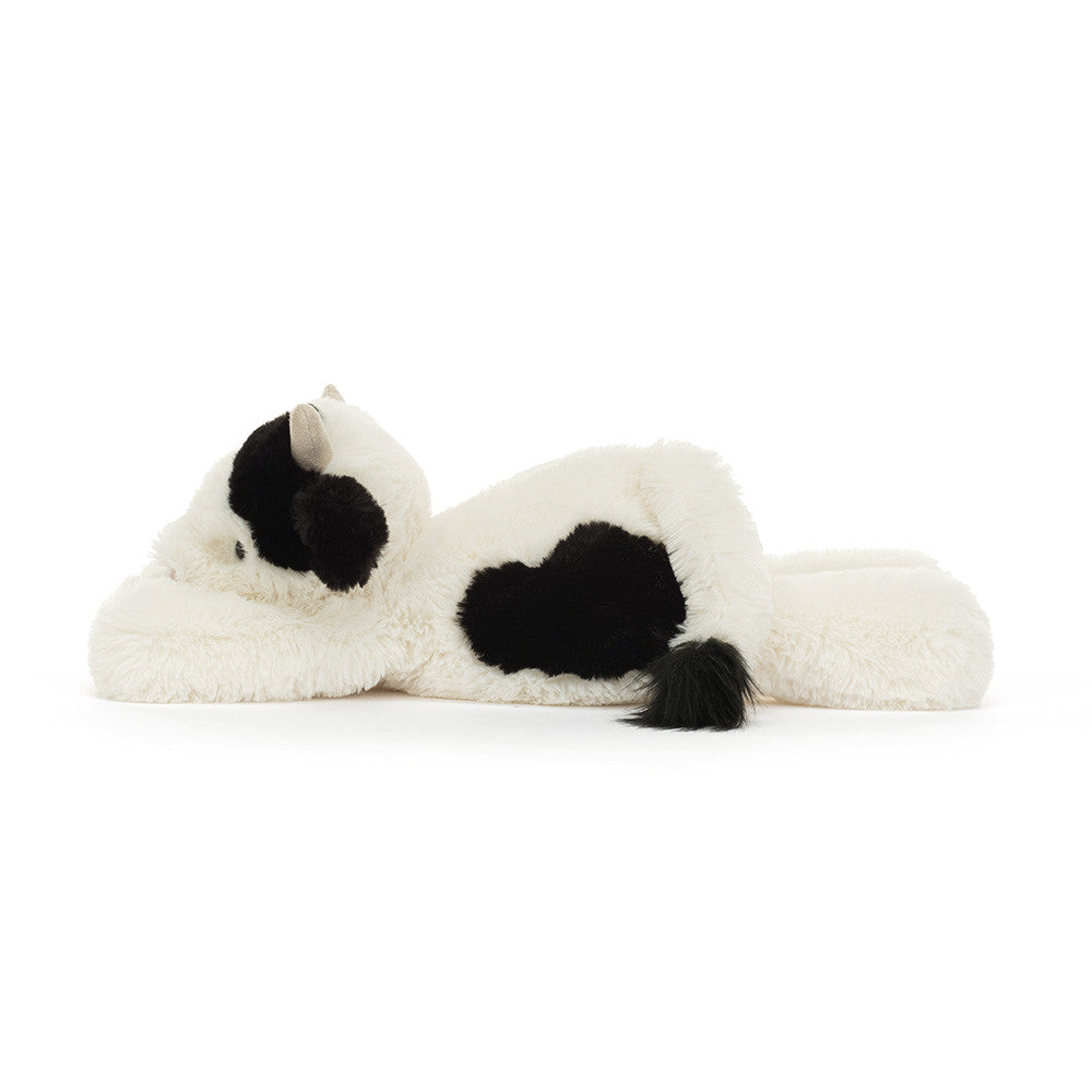 Vista lateral do Peluche Jellycat Smudge Cow deitado com pelo macio