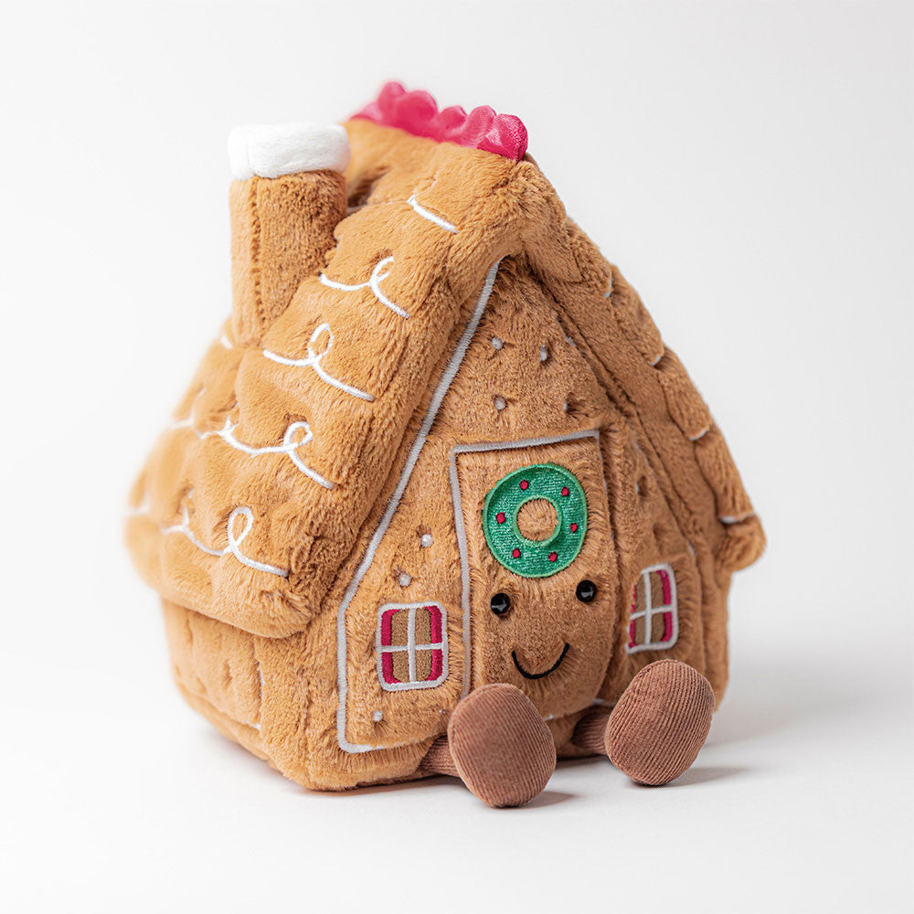 Amuseables Gingerbread House da Jellycat vista de frente – casinha de gengibre de peluche com expressão sorridente e detalhes natalícios.