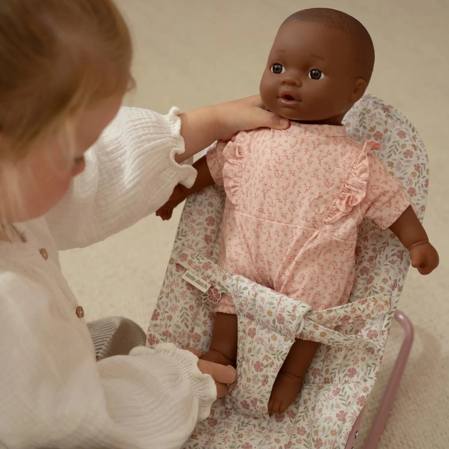 Menina que introduz a boneca na Espreguiçadeira para Bonecas Soft Flowers